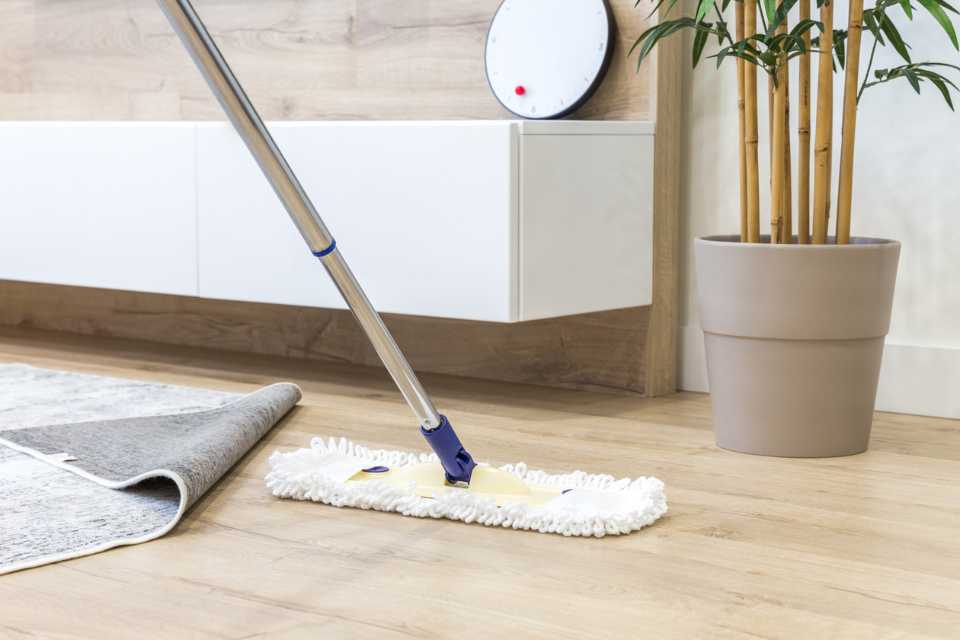 dry mopping light white oak look luxury vinyl in bathroom